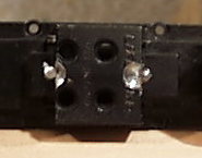 bottom of frame showing screws holding motor.
